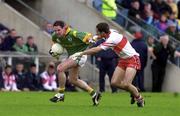 20 May 2000; Ronan Fitzsimons of Meath in action against Sean Martin Lockhart of Derry during the Church & General National Football League Final Replay match between Derry and Meath at St Tiernach's Park in Clones, Monaghan. Photo by David Maher/Sportsfile