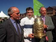 3 May 2000; Trainer Ted Walsh, left, jockey Ruby Walsh, centre, and owner Dermot Desmondon with the Gold Cup after sending out Commanche Court to win the Punchestown Heineken Gold Cup at Punchestown Racecourse in Kildare. Photo by Matt Browne/Sportsfile