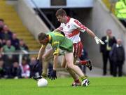 20 May 2000; Trevor Giles of Meath in action against Anthony Tohill of Derry during the Church & General National Football League Final Replay match between Derry and Meath at St Tiernach's Park in Clones, Monaghan. Photo by David Maher/Sportsfile