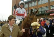 13 April 2004; Jockey Timmy Murphy is lead into the winners enclosure by Ruairi McCloy, son of owner Mrs Seamus McCloy, after riding Hi Cloy to victory in the Powers Gold Cup at Fairyhouse Racecourse in Ratoath, Meath. Photo by Damien Eagers/Sportsfile
