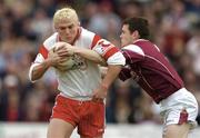 25 April 2004; Owen Mulligan of Tyrone in action against Declan Meehan of Galway during the Allianz National Football League Semi-Final Replay match between Galway and Tyrone at Pearse Stadium in Galway. Photo by Brian Lawless/Sportsfile