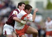 25 April 2004; Philip Jordan of Tyrone in action against Declan Meehan of Galway during the Allianz National Football League Semi-Final Replay match between Galway and Tyrone at Pearse Stadium in Galway. Photo by Ray McManus/Sportsfile
