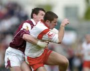 25 April 2004; Philip Jordan of Tyrone in action against Declan Meehan of Galway during the Allianz National Football League Semi-Final Replay match between Galway and Tyrone at Pearse Stadium in Galway. Photo by Ray McManus/Sportsfile