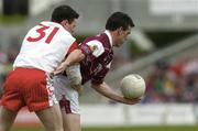 25 April 2004; Padraig Joyce of Galway is tackled by Conor Gormley of Tyrone during the Allianz National Football League Semi-Final Replay match between Galway and Tyrone at Pearse Stadium in Galway. Photo by Ray McManus/Sportsfile