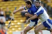 25 April 2004; John Carroll of Tipperary holds off Tony Browne of Waterford on his way to scoring his side's opening goal during the Allianz National Hurling League Group 1 Round 3 match between Tipperary and Waterford at Semple Stadium in Thurles, Tipperary. Photo by Damien Eagers/Sportsfile