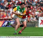 7 May 2000; Cillian Farrell of Offaly in action against Peter McGinnity of Louth during the Church & General National Football League Division 2 Final between Louth and Offaly at Croke Park in Dublin. Photo by Brendan Moran/Sportsfile