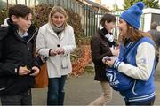 4 March 2015; Jessica McGurk, a member of the Leinster Rugby Blue Crew, hands out free Leinster Rugby watches to fans before the match. Bank of Ireland Leinster Schools Senior Cup Semi-Final, Cistercian College Roscrea v Newbridge College, Donnybrook Stadium, Donnybrook, Dublin. Picture credit: Cody Glenn / SPORTSFILE