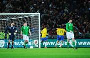 6 February 2008; A dejected  Republic of Ireland players, left to right, Shay Given, Richard Dunne and John O'Shea look on as Robson Souza, 11, Brazil, celebrates with his team-mates after scoring his side's first goal. International Friendly, Republic of Ireland v Brazil, Croke Park, Dublin. Picture credit; David Maher / SPORTSFILE