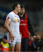 7 March 2015; Cathal McCarron, Tyrone, in conversation with physio Mark Harte after picking up an injury. Allianz Football League, Division 1, Round 4, Dublin v Tyrone. Croke Park, Dublin. Picture credit: Piaras Ó Mídheach / SPORTSFILE