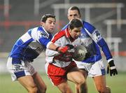 16 February 2008; Conleith Gilligan, Derry, in action against Cathal Ryan, left, and Darren Rooney, Laois. Allianz National Football League, Division 1, Round 2, Laois v Derry, O'Moore Park, Portlaoise, Co. Laois. Picture credit; Pat Murphy / SPORTSFILE *** Local Caption ***