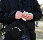 17 February 2008; A ticket seller counts cash outside the ground. Allianz National Hurling League, Division 1B, Round 2, Clare v Laois, Scarriff, Co. Clare. Picture credit; Ray McManus / SPORTSFILE