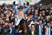 10 March 2015; Ruby Walsh is led into the winner's enclosure after winning the Arkle Challenge Trophy on Un De Sceaux. Cheltenham Racing Festival 2015, Prestbury Park, Cheltenham, England. Picture credit: Ramsey Cardy / SPORTSFILE