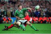 3 February 2002; Brian O'Driscoll, Ireland, releases the ball despite being tackled by Kevin Morgan, Wales. Ireland v Wales, Six Nations Championships, Landsdowne Road, Dublin. Picture credit: Matt Browne / SPORTSFILE