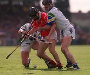 26 March 2000; Ben O'Connor of Cork is tackled by Tom Feeney, right, and James O'Connor of Waterford during the Church & General National Hurling League Division 1B Round 4 match between Waterford and Cork at Walsh Park in Waterford. Photo by Aoife Rice/Sportsfile
