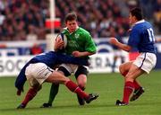 19 March 2000; Brian O'Driscoll of Ireland is tackled by Stephene Glas, left, and Cedric Desbrosse, 13, of France during the Six Nations Rugby Championship match between France and Ireland at Stade de France in Paris, France. Photo by Matt Browne/Sportsfile