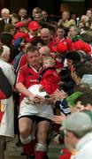 27 May 2000; Munster captain Mick Galwey, holding his daughter Neassa and the runners up plaque, following his side's defeat in the Heineken Cup Final between Munster and Northampton Saints at Twickenham Stadium in London, England. Photo by Brendan Moran/Sportsfile