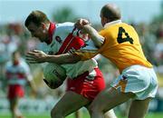 18 June 2000; Johnny McBride of Derry in action against Anto Finnegan of Antrim during the Bank of Ireland Ulster Senior Football Championship Semi-Final match between Antrim and Derry at Casement Park in Derry. Photo by David Maher/Sportsfile