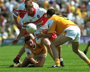 18 June 2000; Aidan Morris of Antrim offloads possession to team-mate Martin Mulholland despite the attention of Derry's Niall McCusker during the Bank of Ireland Ulster Senior Football Championship Semi-Final match between Antrim and Derry at Casement Park in Derry. Photo by David Maher/Sportsfile
