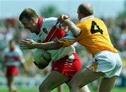 18 June 2000; Johnny McBride of Derry in action against Anto Finnegan of Antrim during the Bank of Ireland Ulster Senior Football Championship Semi-Final match between Antrim and Derry at Casement Park in Derry. Photo by David Maher/Sportsfile