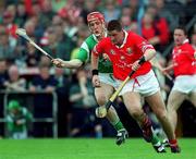 4 June 2000; Fergal McCormack of Cork in action against Ollie Moran of Limerick during the Guinness Munster Senior Hurling Championship Semi-Final match between Cork and Limerick at Semple Stadium in Thurles, Tipperary. Photo by Ray McManus/Sportsfile