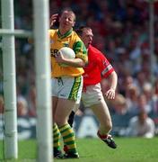 18 June 2000; Kerry goalkeeper Declan O'Keeffe grimaces after a challenge by Cork's Philip Clifford which resulted in the Cork player being given a yellow card by referee Mick Curley during the Bank of Ireland Munster Senior Football Championship Semi-Final match between Kerry and Cork at Fitzgerald Stadium in Killarney, Kerry. Photo by Brendan Moran/Sportsfile