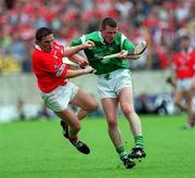4 June 2000; Mark Foley of Limerick in action against Michael O'Connell of Cork during the Guinness Munster Senior Hurling Championship Semi-Final match between Cork and Limerick at Semple Stadium in Thurles, Tipperary. Photo by Ray McManus/Sportsfile