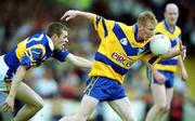 25 June 2000; Ronan Slattery of Clare in action against Niall Fitzgerald of Tipperary during the Bank of Ireland Munster Senior Football Championship Semi-Final match between Clare and Tipperary at the Gaelic Grounds in Limerick. Photo by Brendan Moran/Sportsfile