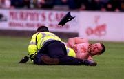 9 July 2000; A streaker is tackled by a member of An Garda Síochána during the Pre-Season Friendly match between Bray Wanderers and Celtic at the Carlisle Grounds in Bray, Wicklow. Photo by Ray Lohan/Sportsfile