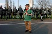 28 April 2004; Republic of Ireland supporter Alex O'Brien, born in Poland, stands outside the WKS Zawisza Stadium, Bydgoszcz, in front of riot police ahead of the International Friendly match between Poland and Republic of Ireland at the WKS Zawisza Stadium in Bydgoszcz, Poland. Photo by David Maher/Sportsfile