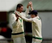5 May 2004; Ireland's Gerald Dros, left, congratulates Eoin Morgan after he caught Surrey's Allie Brown, not pictured, during the Cheltenham & Gloucester Trophy Second Round match between Ireland and Surrey at Clontarf Cricket Club in Castle Avenue, Dublin. Photo by Matt Browne/Sportsfile