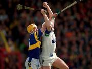 28 May 2000; Waterford's Fergal Hartley fields the sloithar ahead of Tipperary's Liam Cahill during the Guinness Munster Senior Hurling Championship Quarter-Final match between Tipperary and Waterford at Páirc Uí Chaoimh in Cork. Photo by Brendan Moran/Sportsfile