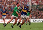 7 July 1996; Tipperary's Colm Bonnar holds off the challenge of Frankie Carroll of Limerick during the Guinness Munster Senior Hurling Championship Final between Limerick and Tipperary at the Gaelic Grounds in Limerick. Photo by David Maher/Sportsfile