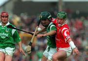 31 May 1998; Fergal Ryan of Cork in action against Damien Quigley of Limerick during the Guinness Munster Senior Hurling Championship Quarter-Final match between Limerick and Cork at the Gaelic Grounds in Limerick. Photo by Ray McManus/Sportsfile