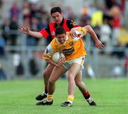 28 May 2000; Gearoid Adams of Antrim in action against Shane Mulholland of Down during the Bank of Ireland Ulster Senior Football Championship Quarter-Final match between Antrim and Down at Casement Park in Belfast, Antrim. Photo by David Maher/Sportsfile