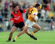 28 May 2000; Gearoid Adams of Antrim in action against Shane Mulholland of Down during the Bank of Ireland Ulster Senior Football Championship Quarter-Final match between Antrim and Down at Casement Park in Belfast, Antrim. Photo by David Maher/Sportsfile