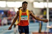 21 March 2015; Joseph Ojemumi, Tallaght AC, crosses the finish line to win the Men's U19 4x200m Relay Final event during Day one of the GloHealth Juvenile Indoor Track and Field Championships. Athlone International Arena, Athlone, Co.Westmeath.  Picture credit: Pat Murphy / SPORTSFILE
