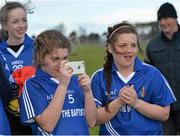 24 March 2015; John the Baptist's Katie Heelan, takes photographs of her team-mates as they celebrate with the cup after the game. TESCO All Ireland PPS Junior B Final, St Michael's Lurgan, Armagh, v John the Baptist, Limerick. Kinnegad, Westmeath. Picture credit: Piaras O Midheach / SPORTSFILE