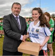 26 March 2015; Con Moynihan, Development Officer with Ladies Football, presents Scoil Mhuire & Padraig captain Roisín Durkin with her sides runners-up medals after the game. TESCO All Ireland PPS Junior C Final, Scoil Mhuire & Padraig, Swinford v Scoil Críost Rí, Portlaoise. Tubberclair, Co. Westmeath. Picture credit: Piaras O Midheach / SPORTSFILE