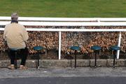 30 March 2008; A punter reads his race card before racing. The Curragh Racecourse, Co. Kildare. Picture credit; Ray McManus / SPORTSFILE