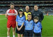 28 March 2015; Match referee Conor Lane with the Derry and Dublin captains, Mark Lynch and Stephen Cluxton,    and mascots Clodagh McCahey, Gael Scoil Chnoc Lamhna, Knocklyon; Daniel Sheridan, Scoil Mhuire, Howth; and Sean McCabe, Gael Scoil Míde, Kilbarrack, before the game. Allianz Football League, Division 1, Round 6, Dublin v Derry. Croke Park, Dublin. Picture credit: Ray McManus / SPORTSFILE