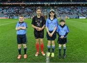 28 March 2015; Mascots Daniel Sheridan, Scoil Mhuire, Howth, Clodagh McCahey, Gael Scoil Chnoc Lamhna, Knocklyon, and Sean McCabe, Gael Scoil Míde, Kilbarrack, with young referee Jasmin Kamtoh, Holy Trinity, NS, second left, before the game. Allianz Football League, Division 1, Round 6, Dublin v Derry. Croke Park, Dublin. Picture credit: Ray McManus / SPORTSFILE
