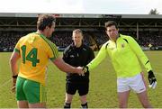29 March 2015; Donegal captain Michael Murphy, left, and Tyrone captain Sean Cavanagh, alongside referee Joe McQuillan, exchange a handshake before the game. Allianz Football League, Division 1, Round 6, Donegal v Tyrone. MacCumhail Park, Ballybofey, Co. Donegal. Picture credit: Oliver McVeigh / SPORTSFILE