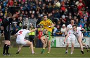 29 March 2015; Martin McElhinney, Donegal, kicks a point despite the attempts of Ronan McNabb and Colm Cavanagh, Tyrone. Allianz Football League, Division 1, Round 6, Donegal v Tyrone. MacCumhail Park, Ballybofey, Co. Donegal. Picture credit: Oliver McVeigh / SPORTSFILE