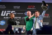 31 March 2015; UFC featherweight Conor McGregor, right, grabs the title belt from UFC featherweight Champion Jose Aldo during a fan event as UFC President Dana White intervenes. The Convention Centre Dublin, Spencer Dock, North Wall Quay, Dublin. Picture credit: Ramsey Cardy / SPORTSFILE