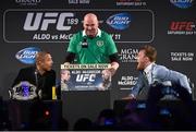 31 March 2015; UFC featherweight Conor McGregor, right, taunts UFC featherweight Champion Jose Aldo, left, during a fan event as UFC President Dana White addresses the crowd. The Convention Centre Dublin, Spencer Dock, North Wall Quay, Dublin. Picture credit: Ramsey Cardy / SPORTSFILE