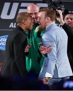 31 March 2015; UFC featherweight Champion Jose Aldo, left, faces off against UFC featherweight title challenger Conor McGregor as UFC President Dana White tries to separate them during a UFC fan event. The Convention Centre Dublin, Spencer Dock, North Wall Quay, Dublin. Picture credit: Ramsey Cardy / SPORTSFILE