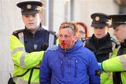 15 April 2008; A Linfield supporter is escorted from the ground by members of An Garda Síochána. Setanta Cup Group 2, St Patrick's Athletic v Linfield, Richmond Park, Inchicore, Dublin. Picture credit: Stephen McCarthy / SPORTSFILE