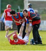 4 April 2015; Damien Casey, Tyrone captain, receives attention for a cramp while play continues late in the game. Allianz Hurling League Division 3A Final, Tyrone v Monaghan. Keady, Co. Armagh. Picture credit: Oliver McVeigh / SPORTSFILE