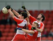 5 April 2015; Kevin Johnston and Oisin Duffy, Derry, in action against Brian Hurley, Cork. Allianz Football League, Division 1, Round 7, Derry v Cork. Owenbeg, Derry. Picture credit: Oliver McVeigh / SPORTSFILE