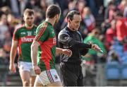 5 April 2015; Referee David Coldrick checks his watch under the gaze of Mayo's Keith Higgins after the game finished in a draw. Allianz Football League, Division 1, Round 7, Mayo v Donegal. Elverys MacHale Park, Castlebar, Co. Mayo. Picture credit: David Maher / SPORTSFILE